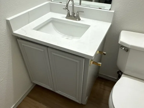 After: guest bathroom vanity painted, with a new countertop and sink, in Lancaster, TX