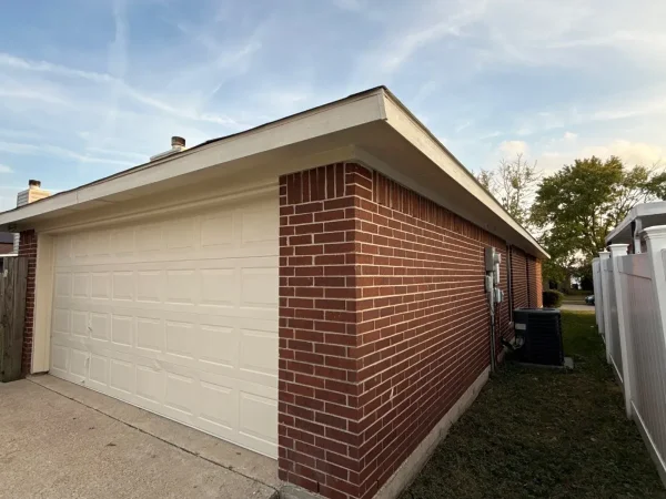 After: garage side with new trim and fresh exterior paint in Lancaster, TX
