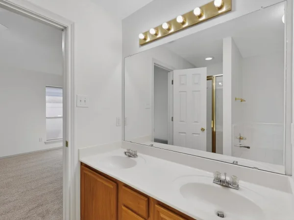 Before: bathroom vanity with original oak cabinet in Lancaster, TX