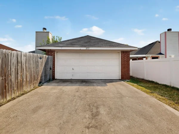 Before: garage and driveway side of the house in Lancaster, TX