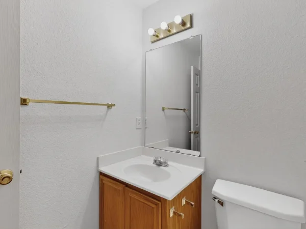 Before: guest bathroom vanity with original oak cabinet in Lancaster, TX