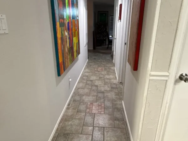 Before: hallway with the old tile floor in Carrollton, TX