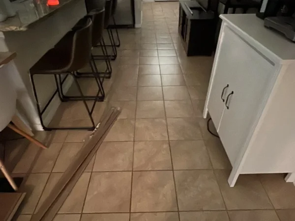 Before: kitchen and breakfast bar with beige tile floor in Keller, TX