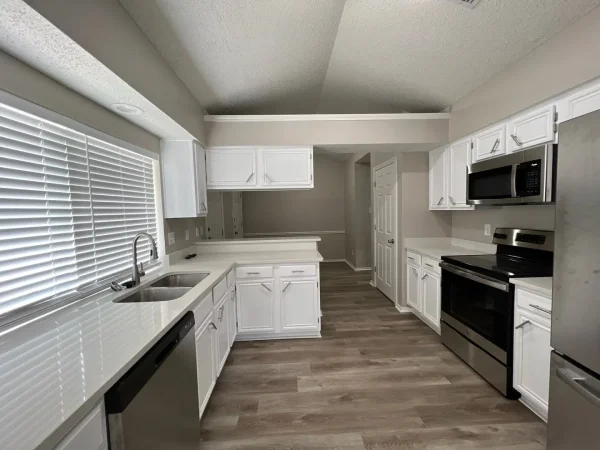 After: kitchen with light gray walls and white cabinets in Dallas, TX