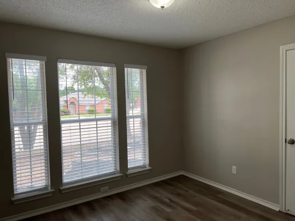 After: bedroom repainted in light gray with white trim in Dallas, TX