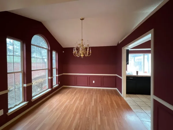 Before: dining area with dark red walls in Dallas, TX
