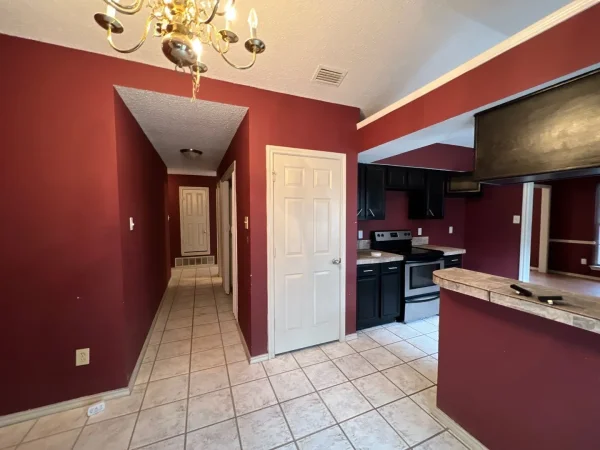 Before: hallway with dark red walls in Dallas, TX