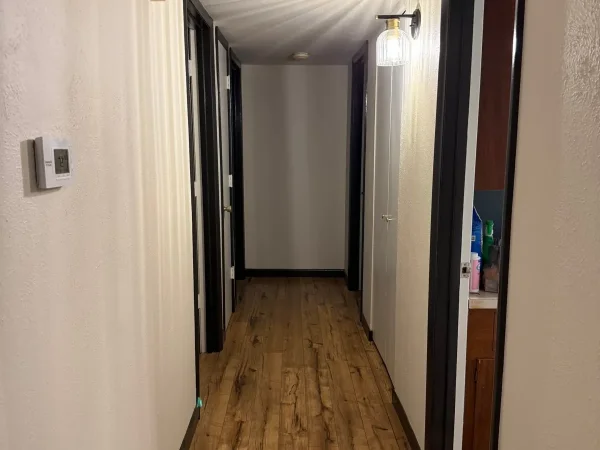 After: freshly painted hallway with a new light fixture in Dallas, TX