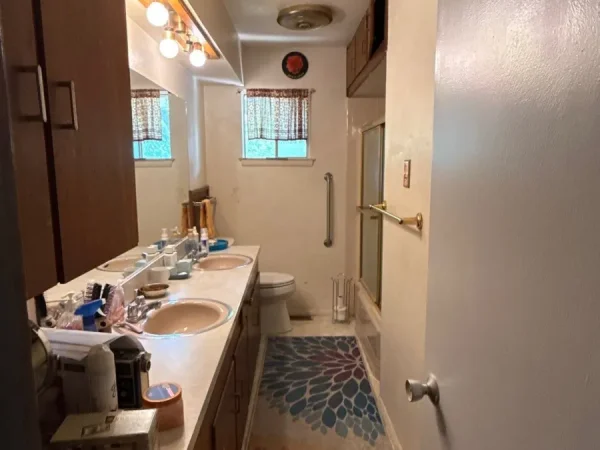 Before: bathroom with dated walls and lighting in Dallas, TX