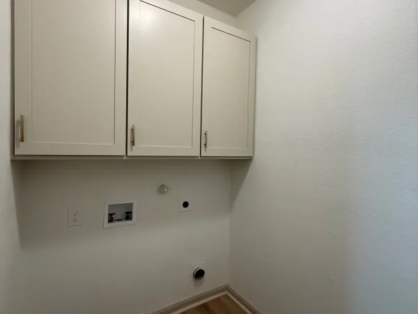 After: laundry room with new cabinets and flooring in Dallas, TX