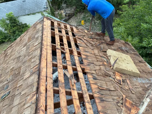 Before: old wood shingles torn off down to spaced board decking in Dallas, TX