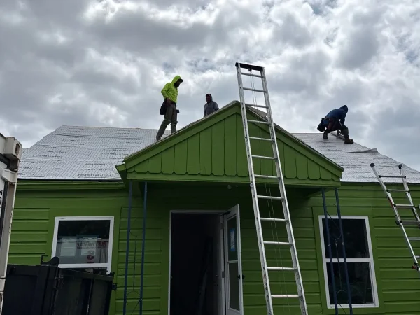 During construction: crew installing the new shingle roof in Dallas, TX