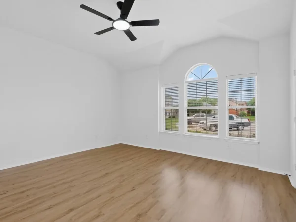 After: bedroom with new paint, flooring and ceiling fan in DeSoto, TX