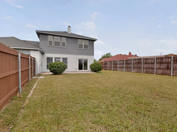 After: backyard with repaired fence in DeSoto, TX